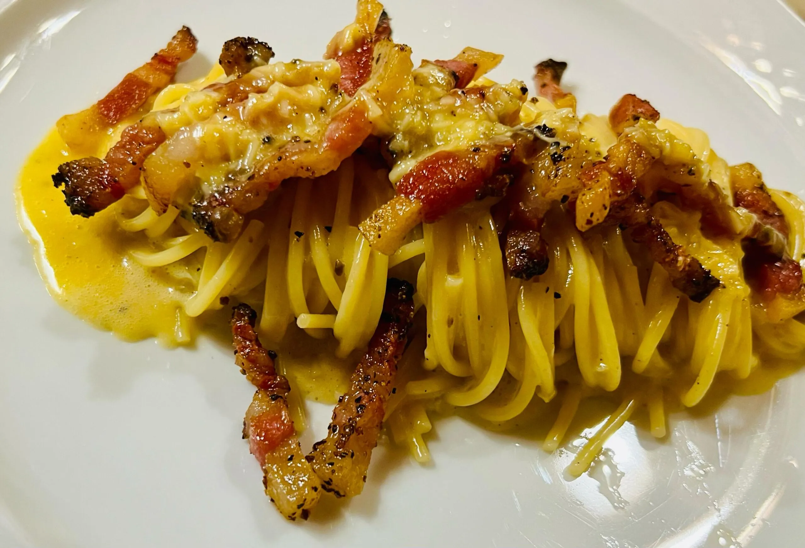 Primo piatto di pasta carbonara con guarnizione croccante